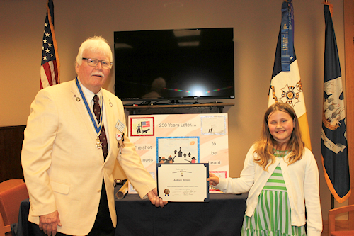 President Compton presented the 2023 Dr. Enemund Meullion Chapter Americanism Poster Contest Winner Aubrey Birinyi with a certificate and a $50 check.  Birinyi's topic was Lexington & Concord – the shot heard round the world – and she discussed how “the shot” continues through history